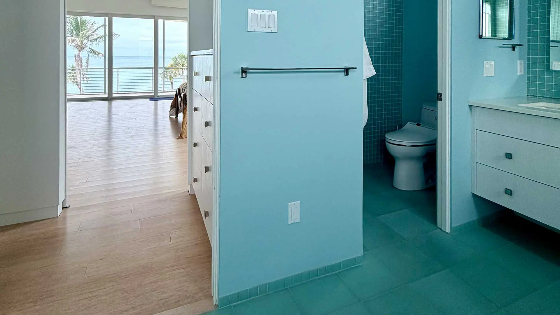 bathroom entryway showing matching tile floor and wall trim