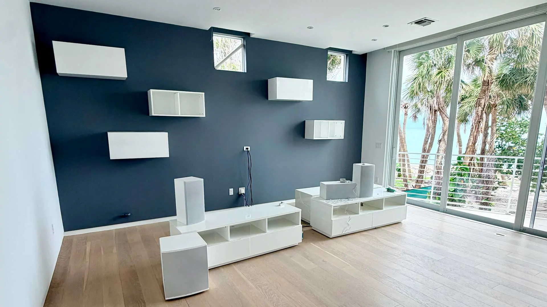modern living area with dark grey accent wall and shelves