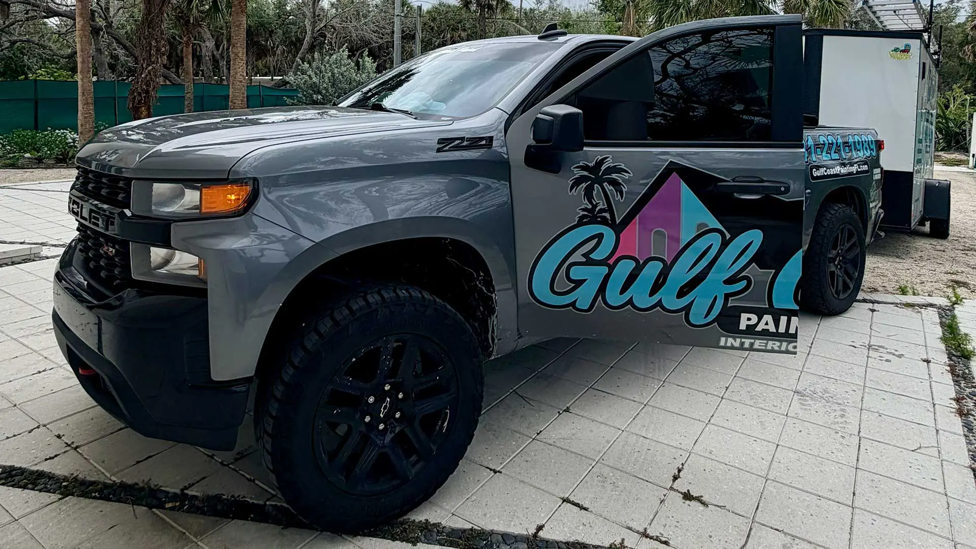 grey pickup truck with Gulf Coast Painting logo on door