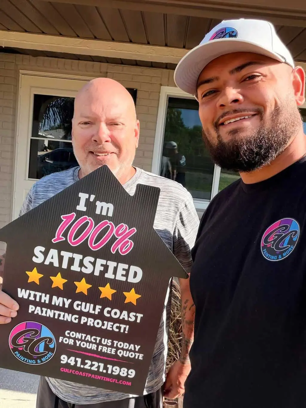 Satisfied homeowner holding a 100% satisfied customer review sign after a residential painting project