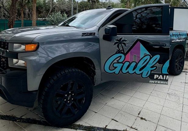 grey pickup truck with Gulf Coast Painting logo on door